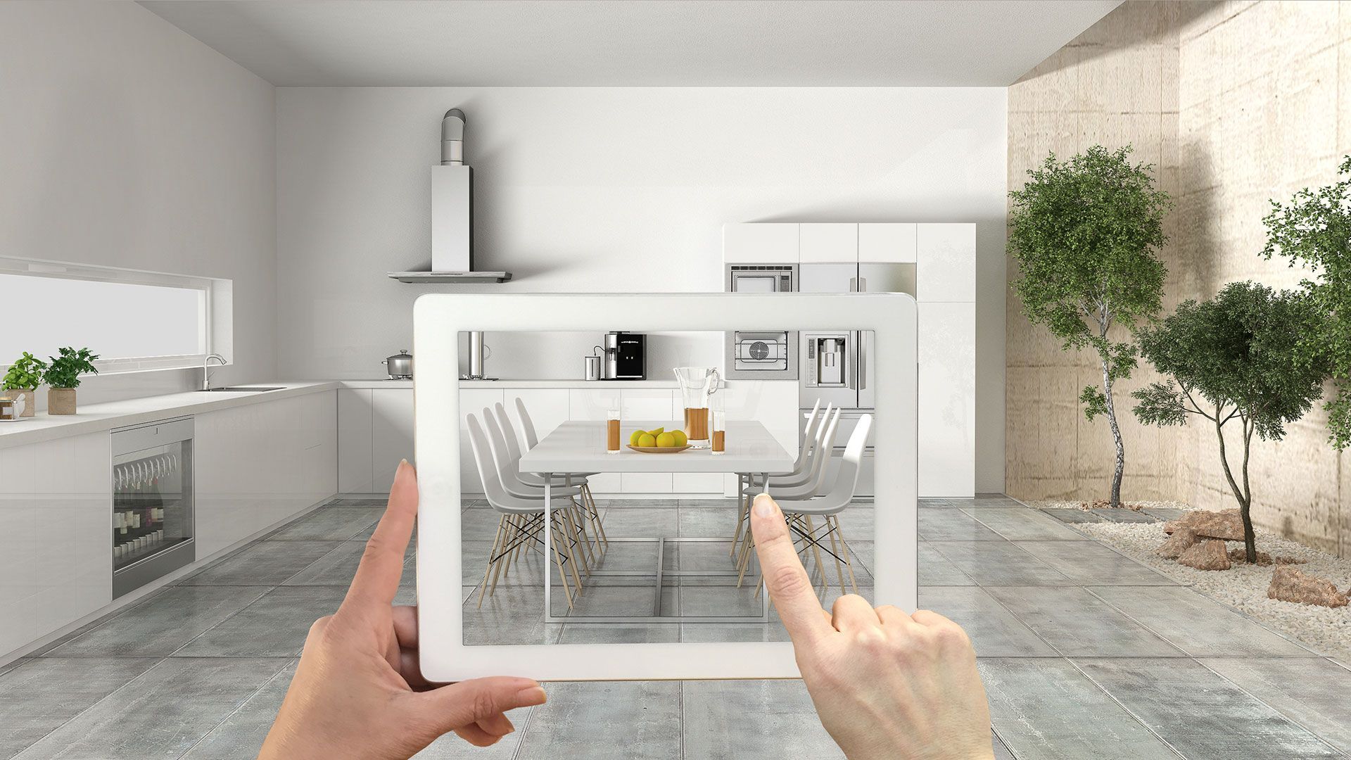 A shopper using a tablet to view a 3D model of a dining table set placed in their kitchen through augmented reality