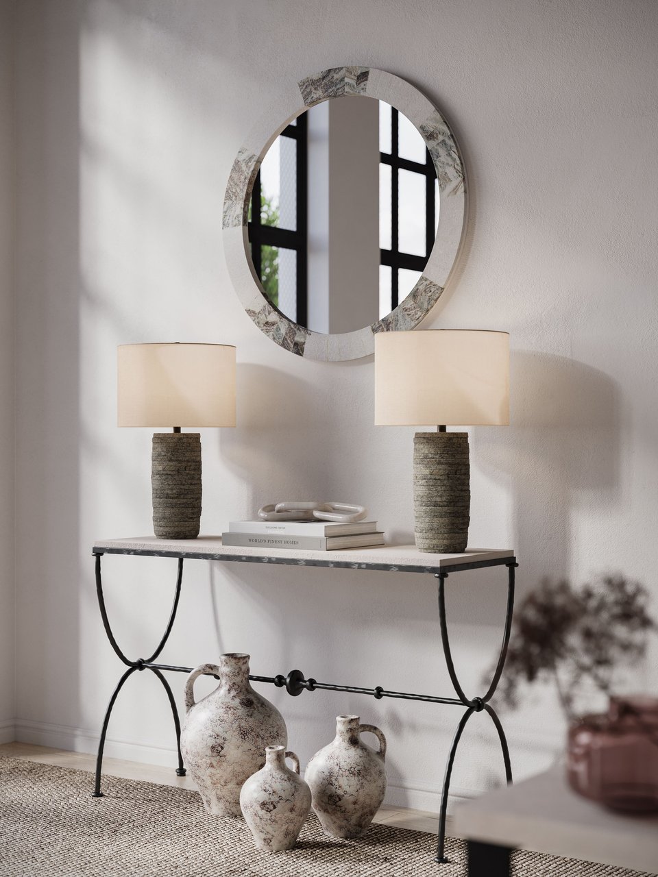 CGI visualization of a wrought iron console table with textured ceramic table lamps, round inlaid mirror, and rustic terracotta jugs in a sunlit interior vignette