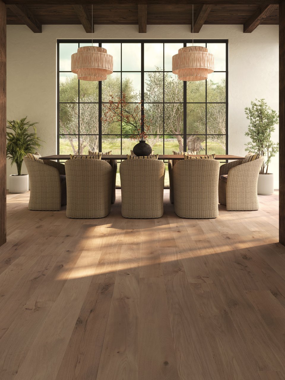 3D rendering of wide plank flooring in a rustic dining room with woven armchairs, rattan pendant lights, exposed beam ceiling, and floor-to-ceiling windows overlooking olive trees