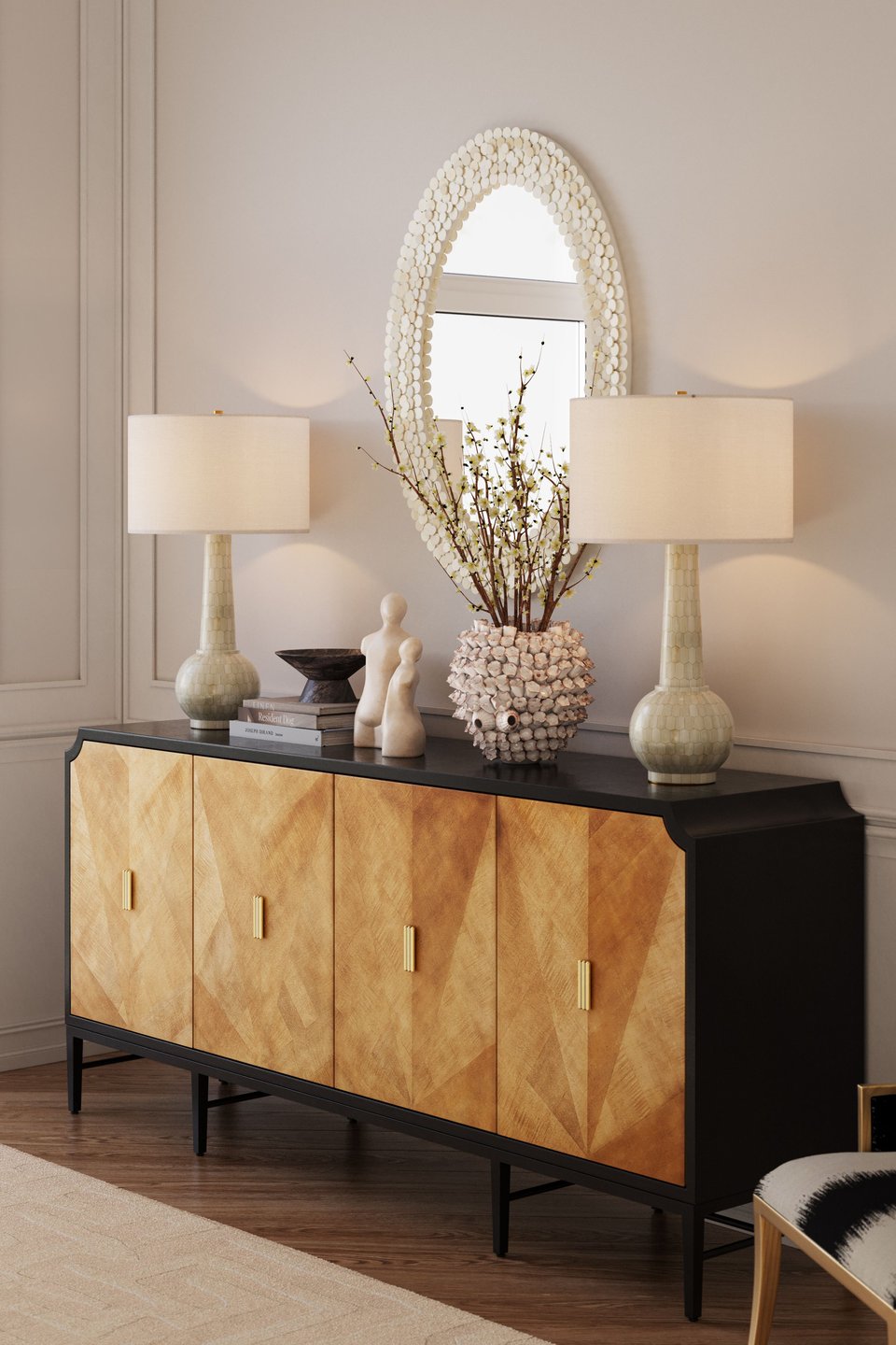 3D rendering of a styled living room vignette featuring ceramic table lamps, a gold-front sideboard with brass handles, and an oval shell-framed mirror against paneled walls