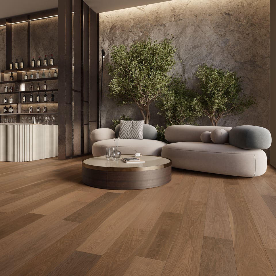 CGI visualization of wide plank flooring in a luxury lounge with curved sofas, round coffee table, indoor olive trees, stone wall, and illuminated bar area